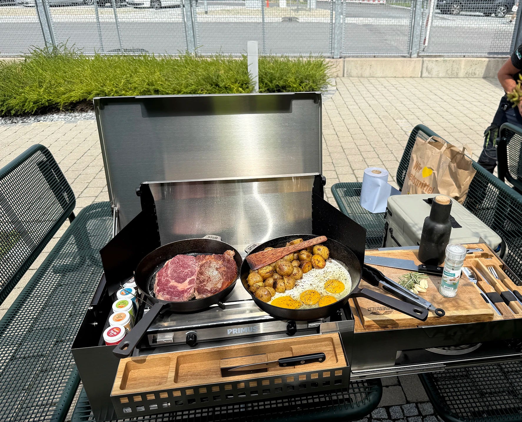 Mobile Küchenbox MOKUBO im Kocheinsatz mit großen Pfannen und Steaks
